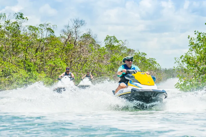 a man riding a wave on a jet ski in the water